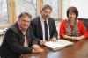 Andreas Fischer (Mitte) unterzeichnet mit den Verwaltungsratsvorsitzenden Maria Rita Zinnecker und Stefan Bosse den Vorstandsvertrag.