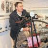Gar nicht so einfach, auf so ein Hochrad aufzusteigen. Erich Deppert demonstriert die Schwierigkeiten in der Fahrradabteilung des Gochsheimer Heimatmuseums.