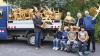 Bürgermeister Thorsten Schwab, Adolf Reichert, Schatzmeister des Förderkreises, Pater Eckart und Rektor Georg Ludwig Hegel (von links) beim Verladen der Kinderstühle. Die Kinder sitzen auf ihren neuen Stühlen.