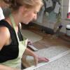 Nina Heiler hilft dem Bäcker Fritz Voll beim Zuschneiden des Knäckebrotes. Nina Heiler hilft dem Bäcker Fritz Voll beim Zuschneiden des Knäckebrotes.