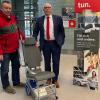 Georg Straub (rechts), Vorstandsvorsitzender der Sparkasse, und Ralf Baumeister, Kreisgeschäftsführer des BRK, zeigen den Treppensteiger.