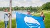 Martin Lüders (Freizeit GmbH), Anne Schmitt (Flussparadies Franken) und Anne-Maria Schneider (Kur & Tourismus Service) beim Hissen der Blauen Flagge am Ostsee Bad Staffelstein.