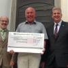 Zweigstellenleiter Heinz Hartmann (links) und Vorstand Martin Weber (rechts) überreichten einen Scheck in Höhe von 2000 Euro an Pfarrer Erich Eyßelein.