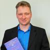 Thorsten Kapperer mit seiner Doktorarbeit zum Thema Leidenschaft und Fußball.