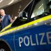 Bayerns Innenminister Joachim Herrmann (CSU) spricht am 15.09.2016 bei einem Übergabetermin für die neuen blauen Dienstautos der bayerischen Polizei in der BMW-Welt in München (Bayern). Die bayerische Polizei nimmt an diesem Tag fünf erste blaue Dienstautos mit neongelber Schrift in Empfang. Foto: Matthias Balk/dpa +++(c) dpa - Bildfunk+++