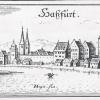 Merian-Stich nach 1605: Zur Rechten hebt sich unverkennbar die Silhouette der Ritterkapelle ab. Auf fast allen Ansichtskarten der Stadt Haßfurt ist ihr Motiv, dem Zeitverständnis entsprechend grafisch gestaltet, deutlich zu erkennen. Ein typisch mittelalterliches  Städtebild mit Stadtmauer und charakteristischen Gebäuden.