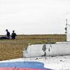 epa04975641 (FILE) People carry a stretcher with a bodybag past the debris of a Boeing 777 Malaysia Airlines flight MH17 airplane, which crashed during flying over the eastern Ukraine region, at the crash site near Donetsk, Ukraine, 19 July 2014. The Dutch Safety Board, on 13 October 2015, will report the results of its investigation into the downing of Malaysia Airlines flight MH17 over Ukraine which killed all 298 people on board. The report is to answer whether the Boeing jet was struck by a Russia-made ground-to-air Buk missile. The aeroplane was en route from Amsterdam to Kuala Lumpur at the time of the July 17, 2014, crash. The Netherlands has taken the lead in the investigation, since most of the dead were Dutch nationals. EPA/ANASTASIA VLASOVA +++(c) dpa - Bildfunk+++