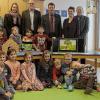 (hä)   Freuen können sich die Kinder aus dem Kinderland in Bad Königshofen über neue interessante Spielsachen, die sie von der Firma KRUG GmbH Verpackungen aus Bad Königshofen geschenkt bekommen haben. Ein Kamishibai und eine Römische Brücke, samt Zubehör bereichern nun das kreative Spielen und Arbeiten der Kinder. 1000 Euro hat der Verpackungsspezialist Jürgen Krug für die Kindereinrichtung übrig gehabt und sie sinnvoll 4in wertiges Spielzeug investiert. Ein Kamishibai ist ein Märchenbilderschaukasten und stammt aus Japan. Das japanische Papiertheater setzt sich aus den Wörtern „kami“ Papier und „shibai“ Schauspiel zusammen und kann mit allen Geschichten bestückt werden. Die Römische Brücke entstammt der Montessori-Philosophie und fördert kreatives Denken und Schaffen. Vor allem das Kamishibai ist bei den Kindern gut angekommen und wurde gleich für eine erste Geschichte eingesetzt, die sich die Besucher und Sponsoren nicht entgehen lassen wollten. Die neue Leiterin des Hauses, Angelika Schönstein (Zweite von rechts in der hinteren Reihe) zeigte sich begeistert von den ganzen neuen Materialien und sieht darin eine richtige Investition, von der alle im Kinderland einen Nutzen haben. Auch Bürgermeister Thomas Helbling (Dritter von rechts, hintere Reihe) und die anwesenden Gemeinderäte freuten sich über die Spende der Verpackungsfirma.