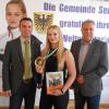 Bürgermeister Oliver Schulze (von links) übergibt Selina Schmidt das Gemeindewappen, die stolz ihre Goldmedaille präsentiert. Über die gemeindliche Ehrung freut sich der Vorsitzende der SG Franken 06 Sennfeld, Michael Stich.