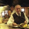 Hier gart die Wurst über offenem Feuer: Senior-Chef Werner Behringer am Grill im Bratwursthäusle mitten in der Nürnberger Altstadt.