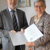 Der Präsident des Landgerichts Würzburg, Dr. Dietrich Geuder, überreicht der bisherigen Amtsgerichtsdirektorin Dr. Luitgard Barthels ihre Ernennungsurkunde zur Vorsitzenden Richterin am Oberlandesgericht.