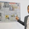 100 Tage im Amt: Schonungens junger Bürgermeister Stefan Rottmann, hier in seinem Büro vor einer Collage der Zeitungsartikel zu seiner Wahl, die ihm Freunde zusammengestellt haben.