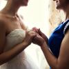 Bride on wedding day holding her mother's hands. Concept of relationship between moms and daughters