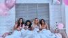 Four attractive young women in pajamas drinking cocktails while lying in the bed with balloons all over the room Four attractive young women in pajamas drinking cocktails while lying in the bed with balloons all over the room