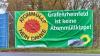 Protest gegen Atommülltransporte: In Bergrheinfeld mussten die Grünen Logo und Parteiname auf dem Banner zukleben.
