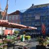 Vorne der wöchentliche grüne Markt von Bad Neustadt, hinten fällt momentan ein hoher Kran und ein "eingepacktes" Gerüst auf. An einem Gebäude am unteren Marktplatz wird seit einiger Zeit schon kräftig gewerkelt.