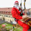 Höhenretter der Berufsfeuerwehr Würzburg seilten sich– als Nikoläuse verkleidet – an der Fassade der Kinderklinik der Uni Würzburg ab und beschenkten die Kinder.