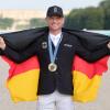 Mit Gold und deutscher Fahne in Versailles