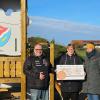 Kathrin Kieser von der VR-Bank Würzburg (Mitte) überreicht Martin Umscheid und Johanna Lieblein (rechts) von der Elternvertretung des Projekts Spielplatzbau in Aufstetten einen Spendenscheck über 7001 Euro.