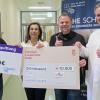 Bei der Spendenübergabe am Uniklinikum Würzburg (von links): Marco Saeed (Gaming gegen Krebs), Gabriele Nelkenstock ("Hilfe im Kampf gegen Krebs"), Dennis Henson ("Letsplay4Charity") und Prof. Dr. Martin Kortüm (UKW).