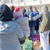 Geflüchtete aus der Ukraine stehen vor den Gebäuden einer Flüchtlingsunterkunft in Köln.