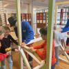 Michael Settele und Martin Lutz vom Bauhof in Mauerstetten unterstützen einige Kinder beim Bau eines Verkaufsstandes.