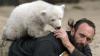 Das vier Monate alte Eisbärbaby Knut klettert im Berliner Zoo auf seinen Pfleger Thomas Dörflein (Archivfoto vom 08.04.2007).