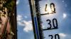 Ein Thermometer an einer Hauswand.