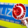 Ein Polizist fordert zum Halten auf. (Symbolbild).