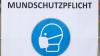 «Mundschutz» und ein Piktogramm eines Maskentragenden Menschen sind auf einem Schild zu sehen.
