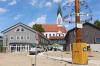 Maibaum, Verwaltungsgebäude und Kirchturm bilden in der Dasinger Ortsmitte eine Sichtachse.