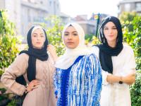 Three women in hijabs standing confidently outdoors